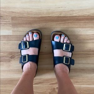 Black leather Arizona Birkenstocks, brass buckles